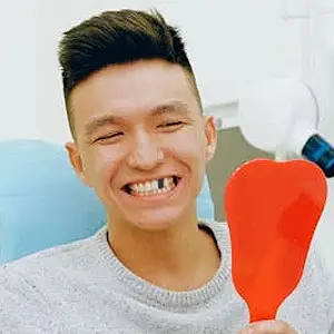 Young man with a missing tooth