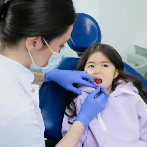 A child getting dental treatment, one of the Smiles of Cary dental specialties
